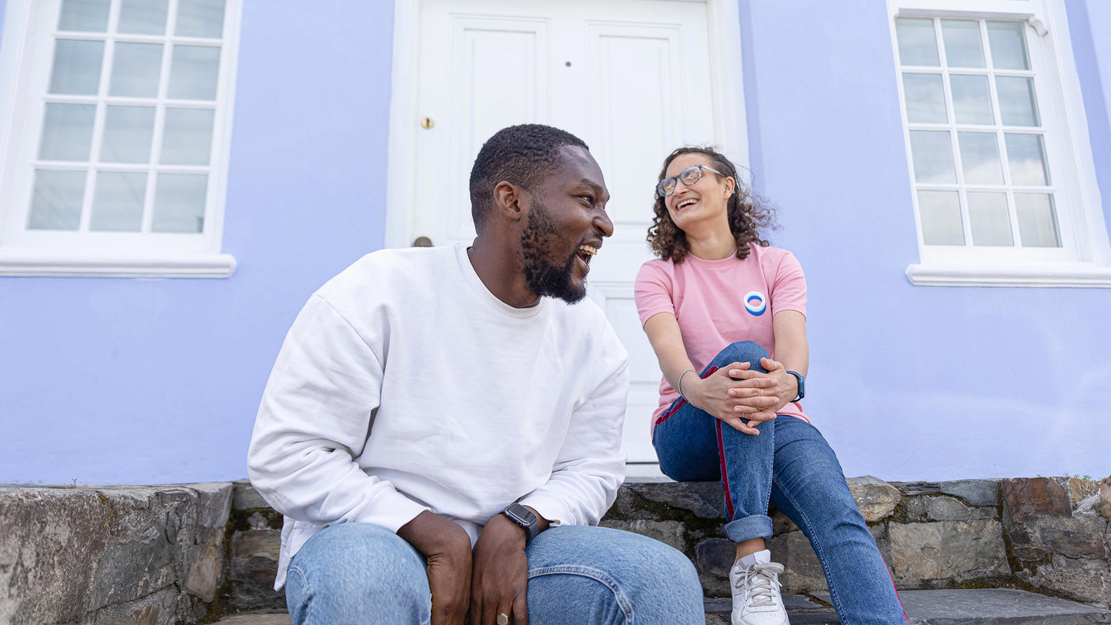 a man and woman sitting on steps