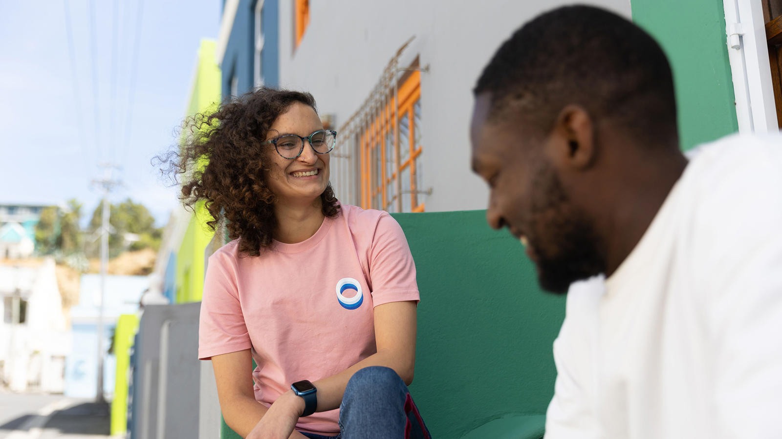 a woman and man sitting on a bench