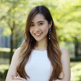 a woman smiling with her arms crossed
