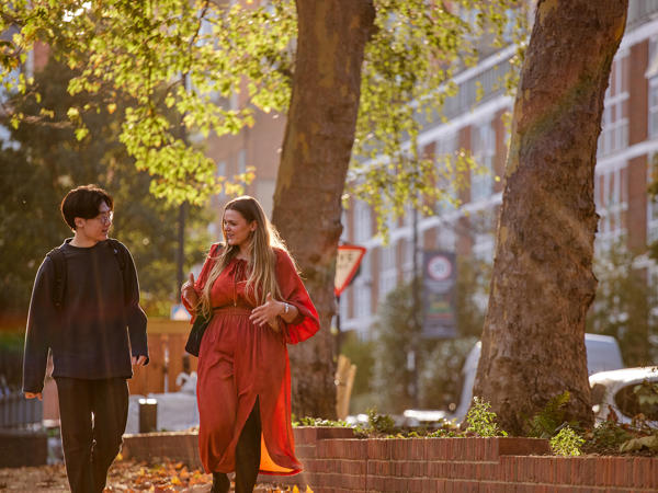 a man and woman walking down a street